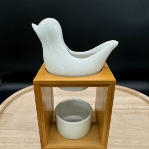 Brûleur d’arômes en forme d’oiseau blanc sur socle en bois